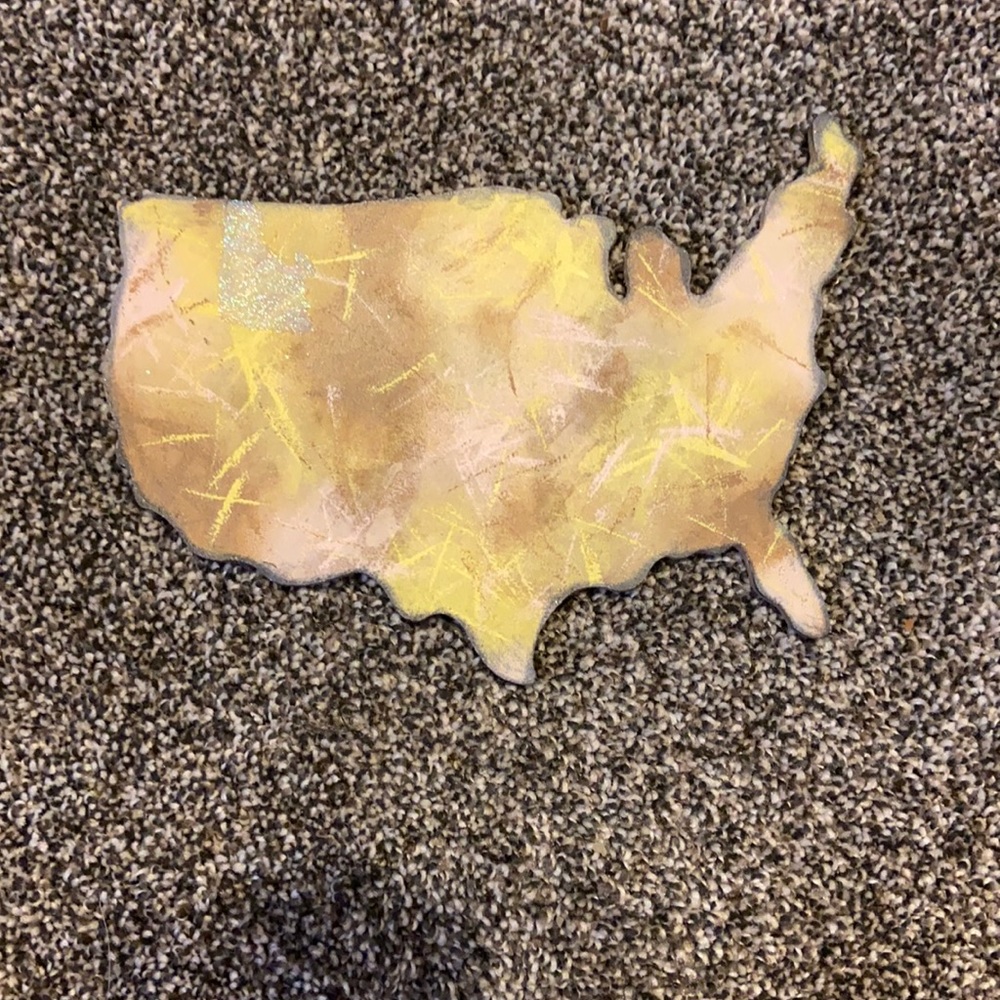 Wooden block of the us with Idaho glittered in